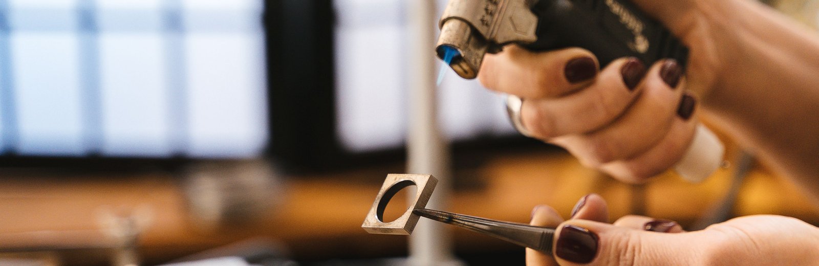 Jeweler hand-crafting a gold ring with precision tools