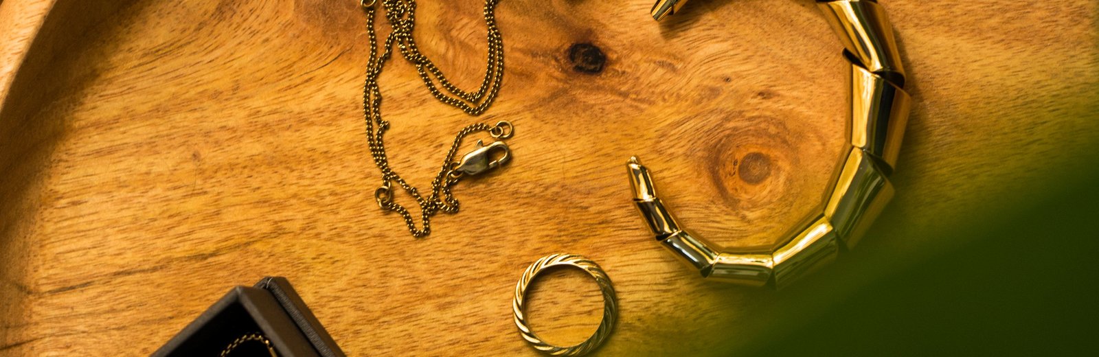 Gold necklaces displayed on a jewelry stand
