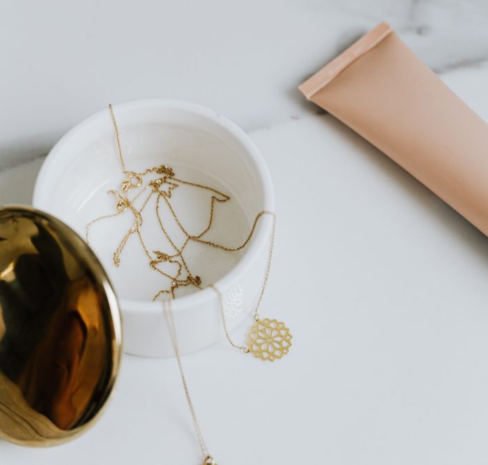 Gold jewelry in marble container