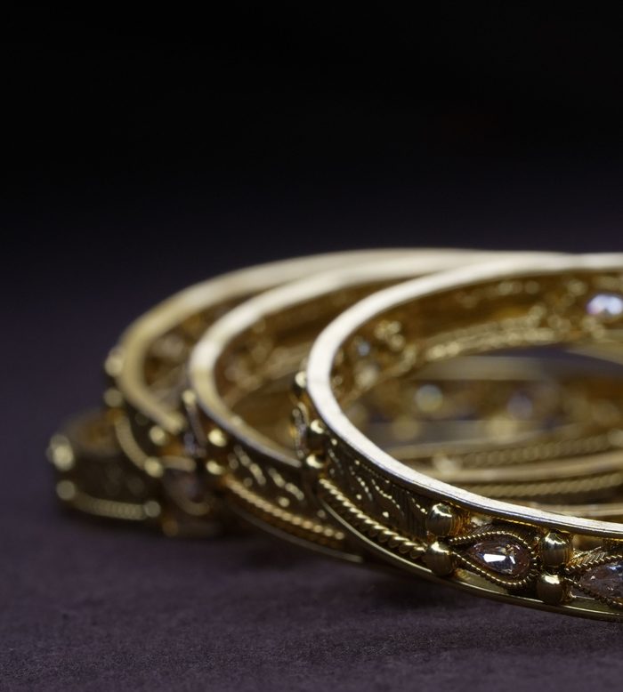 Ornate gold bangles with gemstone accents