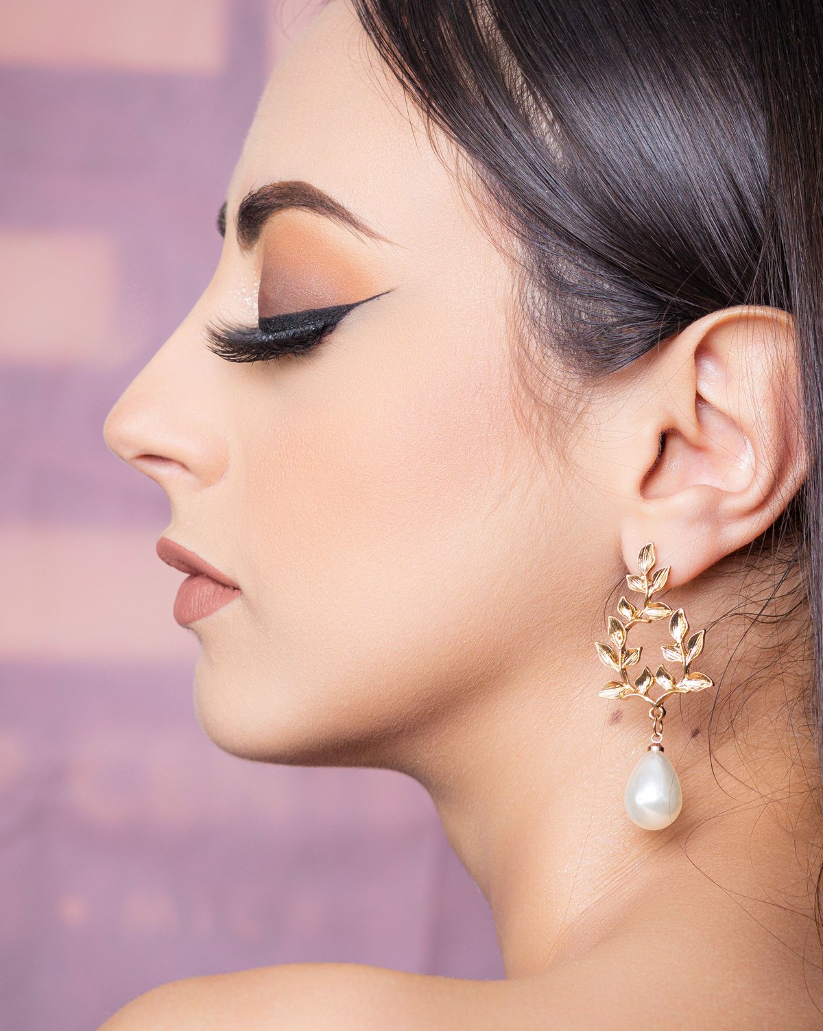 Elegant jewelry model wearing a handcrafted gold earring